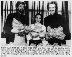 3 students holding gifts for donation