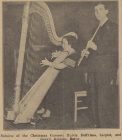 2 musicians performing at the christmas part, one of which is a harpist