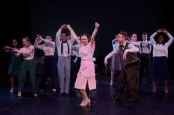 student performing on stage in modern day