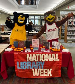 rocky and deacon at the bloomfield campus library at a national library week table