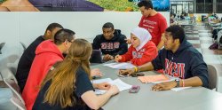 Image of a group of Montclair State students gathered around a table studying.