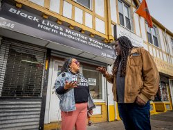 Professor Jason Williams and Brenda “Bre” Azanedo talking on a sidewalk