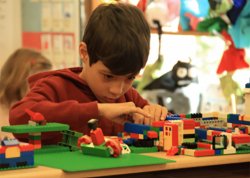 student in classroom playing with Legos