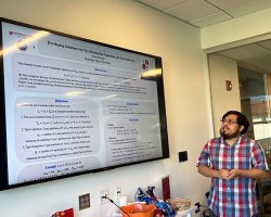 Arnold Rosas reviewing his digital research poster