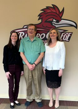 Geena Taite and her family in front of the Ramapo sign