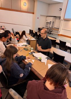 Dr. Bogdan Nita working with students at Math and Art Day 2025