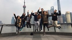 Students jumping in front of Shanghai skyline