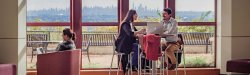 two students studying with NYC skyline in background