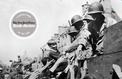 black and white photo of soliders on the back of a truck shaking hands with children