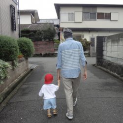 Photo of Chris Mack and his young son walking
