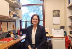 photo of Kathleen Loysen smiling in her office