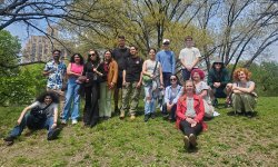Pascale LaFountain joins German Club on a full-day outing in NYC. The group sits and stands on a grassy hill