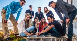 Members of Montclair State University's Environmental Club with a model of their Earthship.