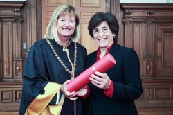 Photo of University of Graz Rector Christa Neuper and Montclair State University President Susan Cole holding Dr. Cole's honorary document.