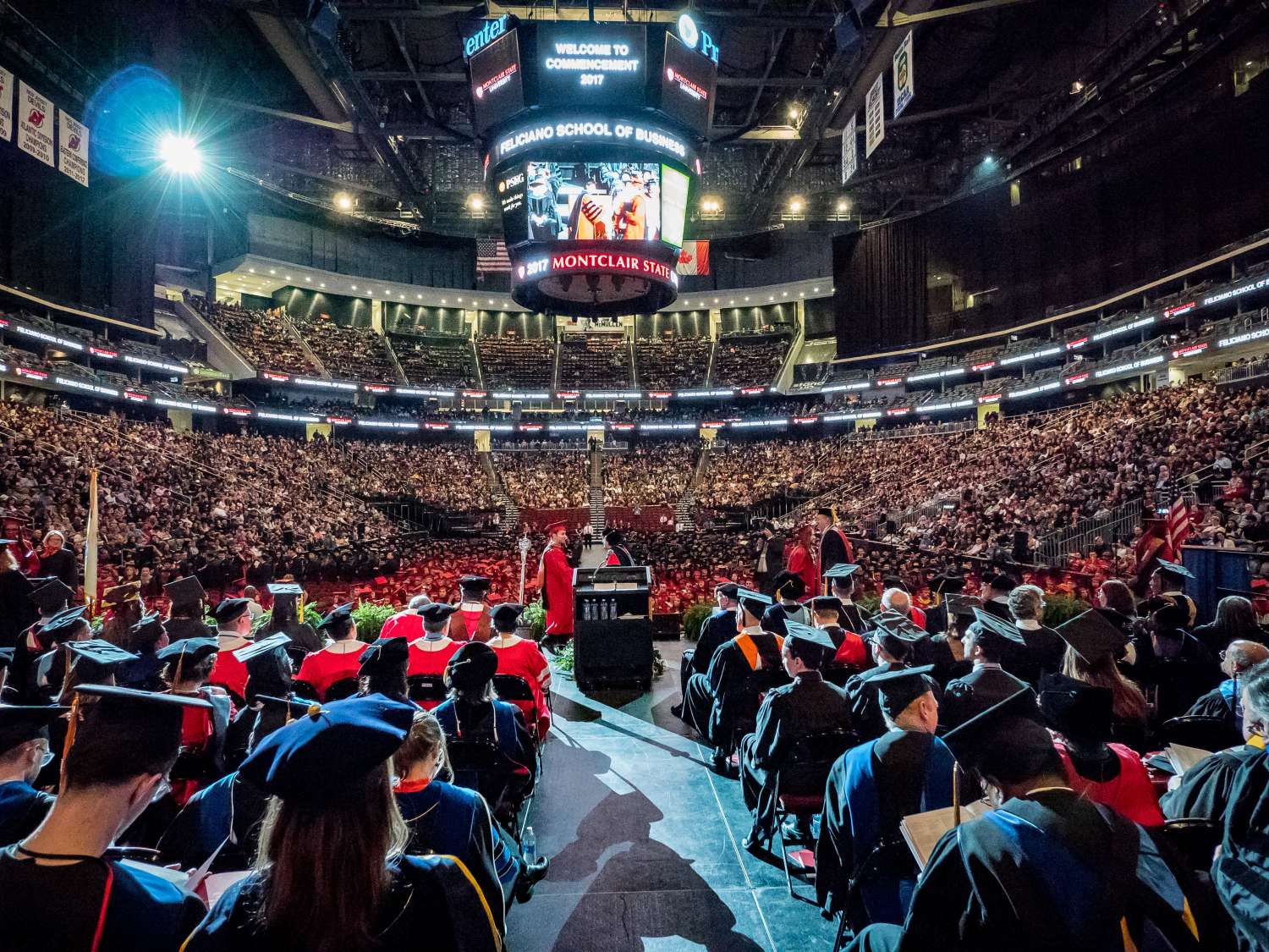 Photo from back of stage at Commencement at Prudential Center as graduates walk across the stage