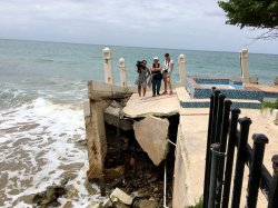 Students in Puerto Rico standing on pier before beach