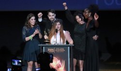 Students accepting College Emmy Award cheering at podium