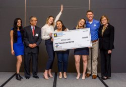 Winners of SBUS pitch contest holding giant check