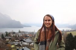 student in front of wide view of fjord
