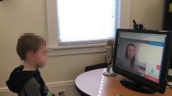 Child having a teleconference with counselor