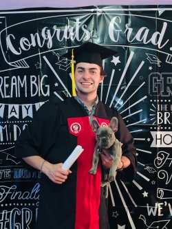 Coldin Grundmeyer proudly displays his mock diploma and new French bulldog, Paco. Photo courtesy of Coldin Grundmeyer.