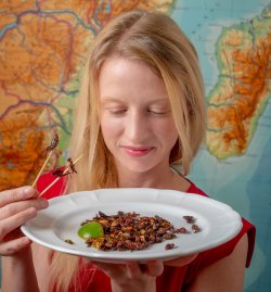 Cortni Borgerson, seen here with a plate of grasshoppers, leads a program to farm the so-called “bacon bugs” in Madagascar to improve food security.