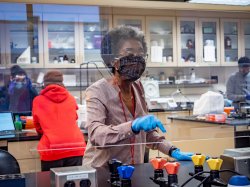 Biology Professor Sandra Adams follows COVID-19 safety protocols in a molecular biology lab.