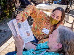 Theresa Hrenko, a resident of Canterbury Village, reads through recipes with Lauren Nuñez.