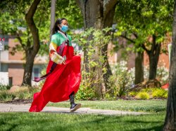 student in traditional korean dress running toward the staging area