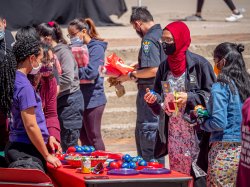 club members staffing a table speak with students interested in club activities
