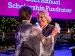 Mary Mochary gives Rose Cali a hug when presenting her with the Mary Mochary and Michael Kasser Award for Philanthropic Leadership.