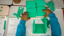 view over elementary school student's shoulder as they use manipulatives in math class
