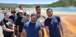 Geology students posed in front of geyser in Yellowstone