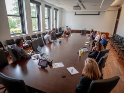 wide view of president's conference room with Koppell and the University Deans