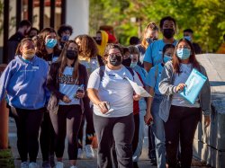 team of volunteers walking across campus as a group