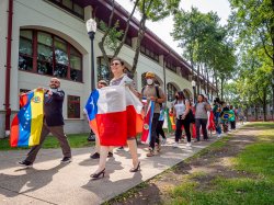 parade of students and staff carrying flags representing various Latin countries