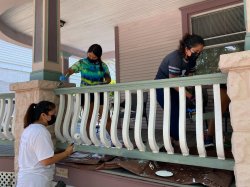 Americacorps students painting a railing