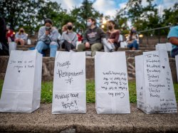 Four luminaria in a row with messages from the campus community