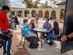 President Jonathan Koppell speaking with students on campus