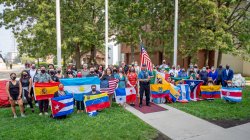 Latino and latina students, faculty and staff displaying flags from their families' ancestry
