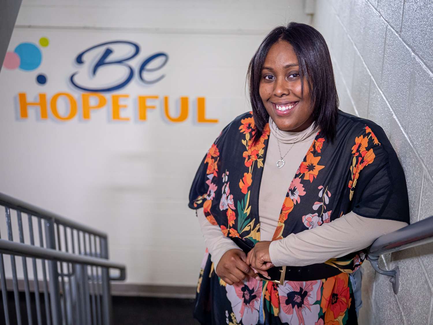 Wheatherly Almonte is a P-CASA in a stairwell at a school with the words "Be Hopeful" in the background