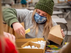 Student volunteer sorting personal care products