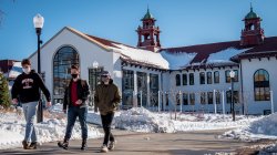 Students walking in front of Cole Hall at Montclair State University in the snow