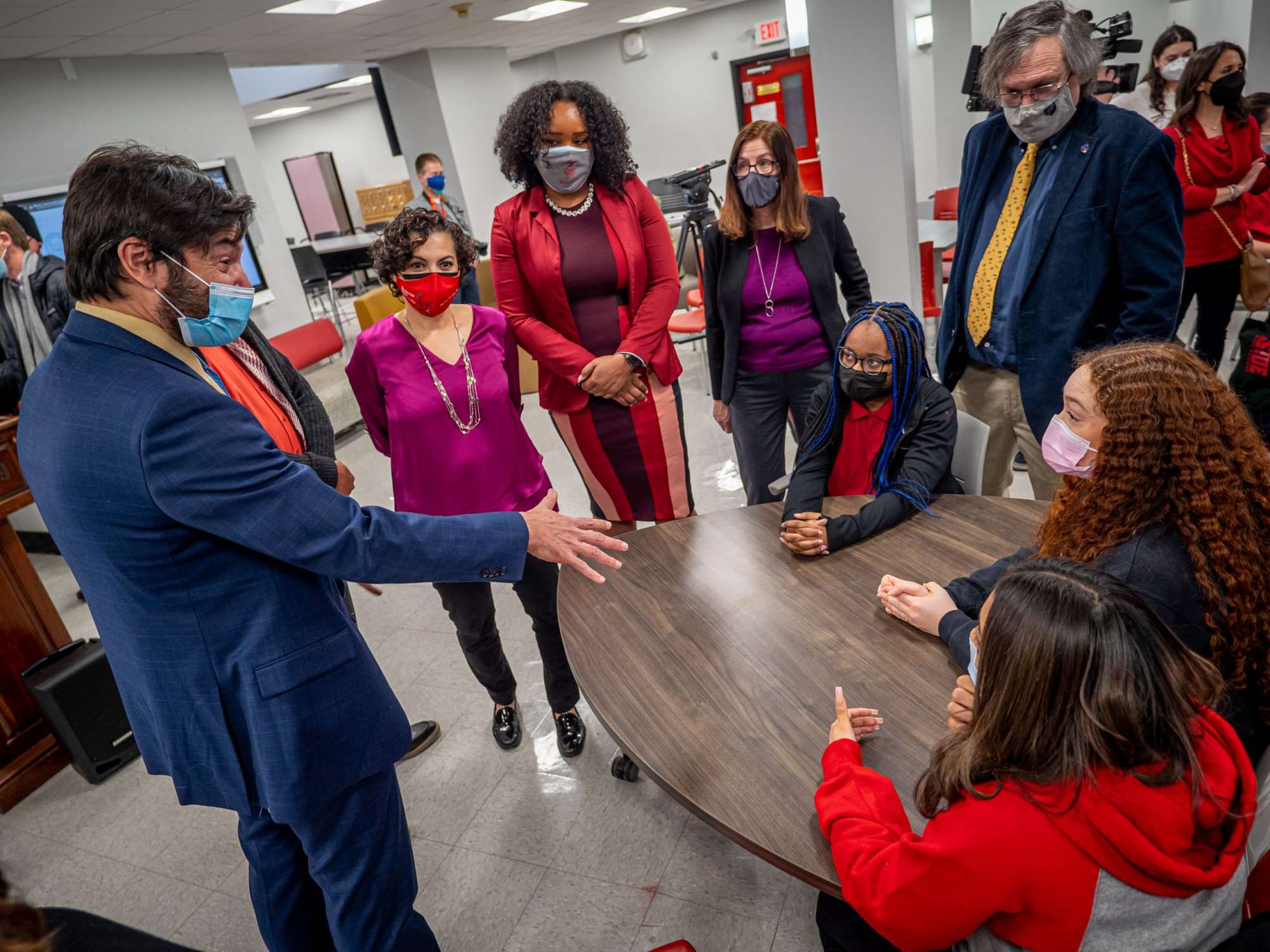 President Jonathan Koppell speaks with Teacher Academy students (seated, L to R) Aniya Mahfood Shockness, Melissa De Almeida, and Liz Guman