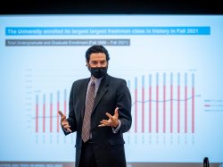 President Koppell in front of a chart