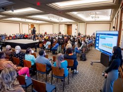 attendees seated around a central stage