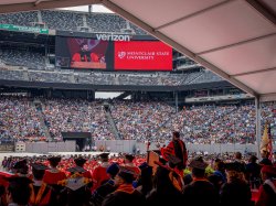 photo of crowds in MetLife stadium as seen from the podium during graduation"