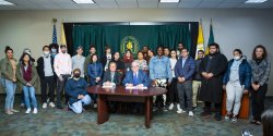 Provost and Senior Vice President for Academic Affairs Junius Gonzales and HCCC President Christopher M. Reber with HCCC students at the signing of the schools' transfer agreement.