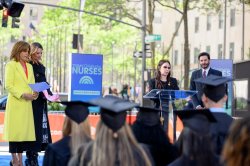 Dean Jan Smolowitz on stage, with President Koppell and Today Show hosts standing beside her.