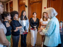 students gathered around Lisa Hoyt